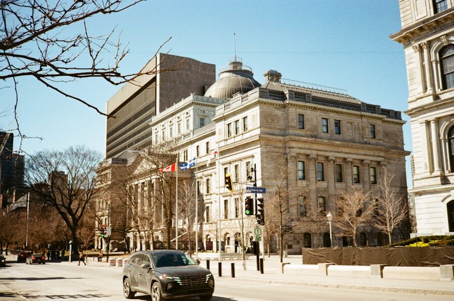 Heritage architecture in downtown Montreal with Quebec and Canadian flags flying