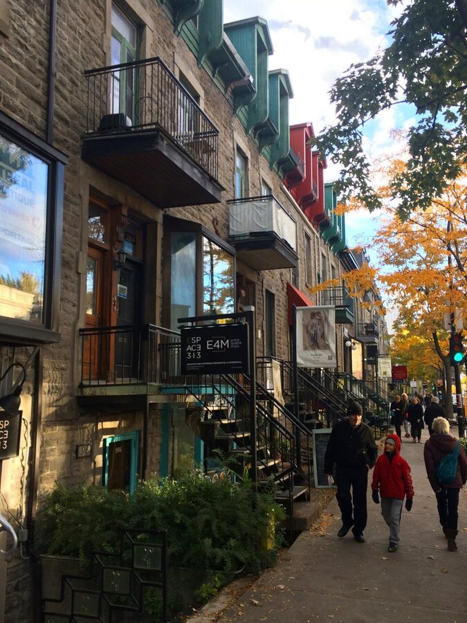 Plateau Mont-Royal triplex with iconic exterior staircases and balconies in Montreal