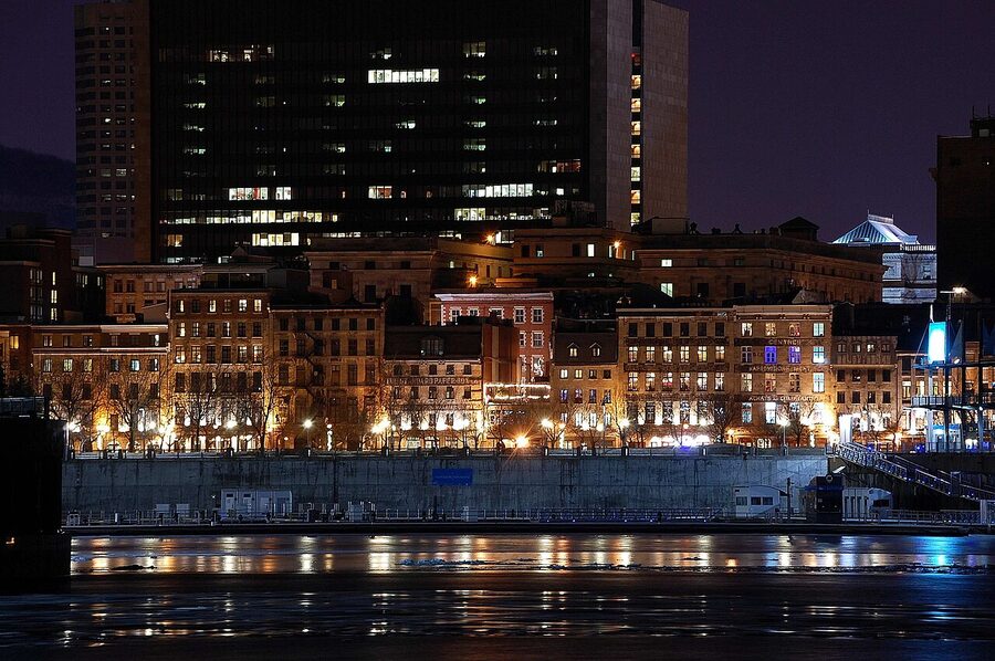 Old Montreal at night, stone buildings glowing along the waterfront