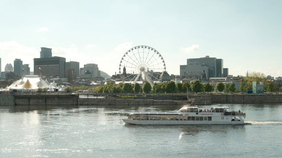 Old Port of Montreal with the Grande Roue ferris wheel and a tour boat on the river
